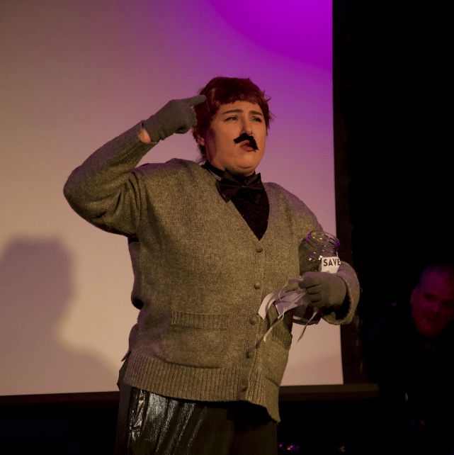 Hannah Breen wears a wig and fake mustache for this Nova Show sketch